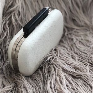 Textured version of the classic white clutch